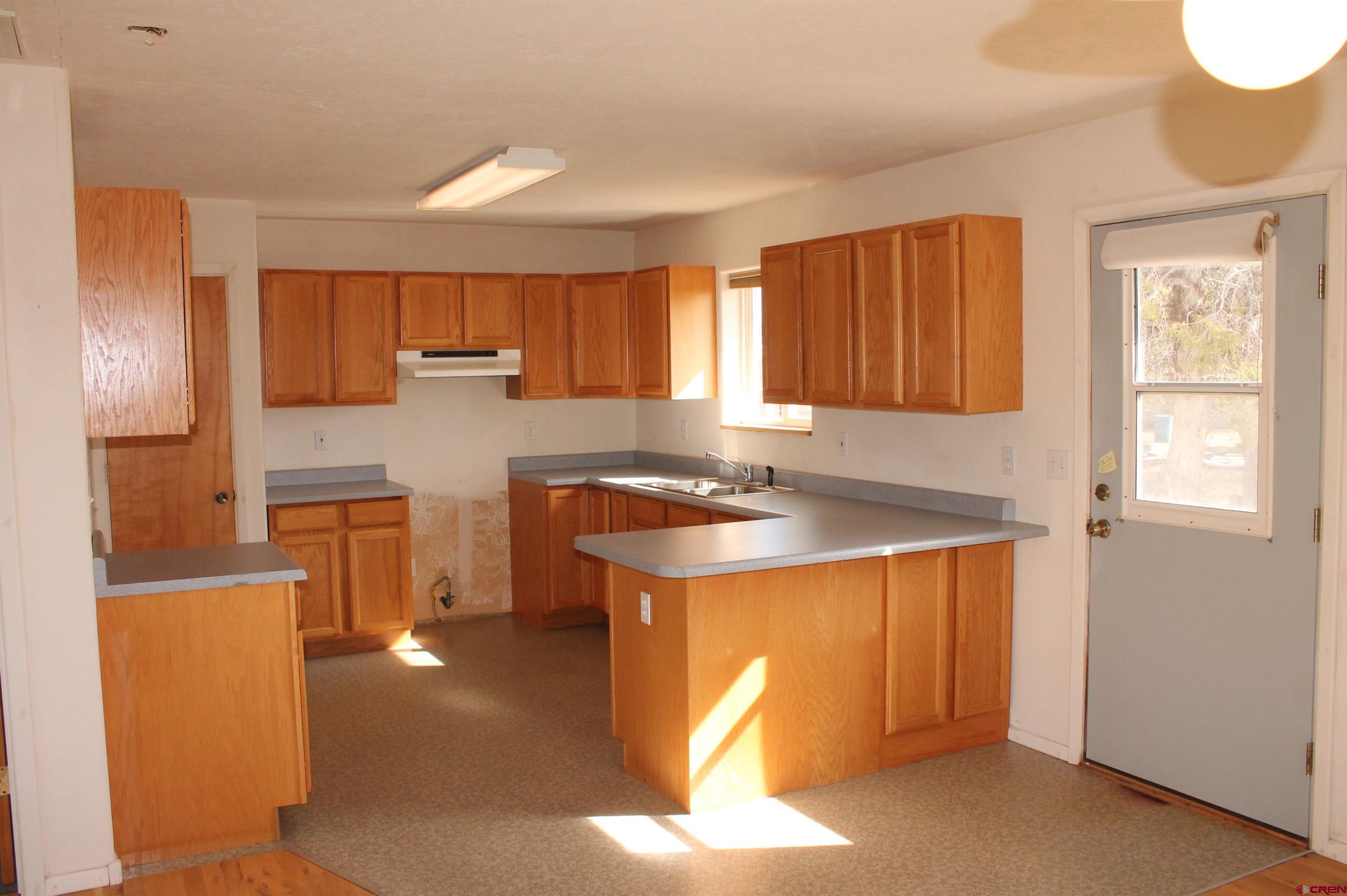 2944 County Road 510 Durango, CO 81303 - Photo 12 of 38 a kitchen with a refrigerator a stove a sink and a cabinets