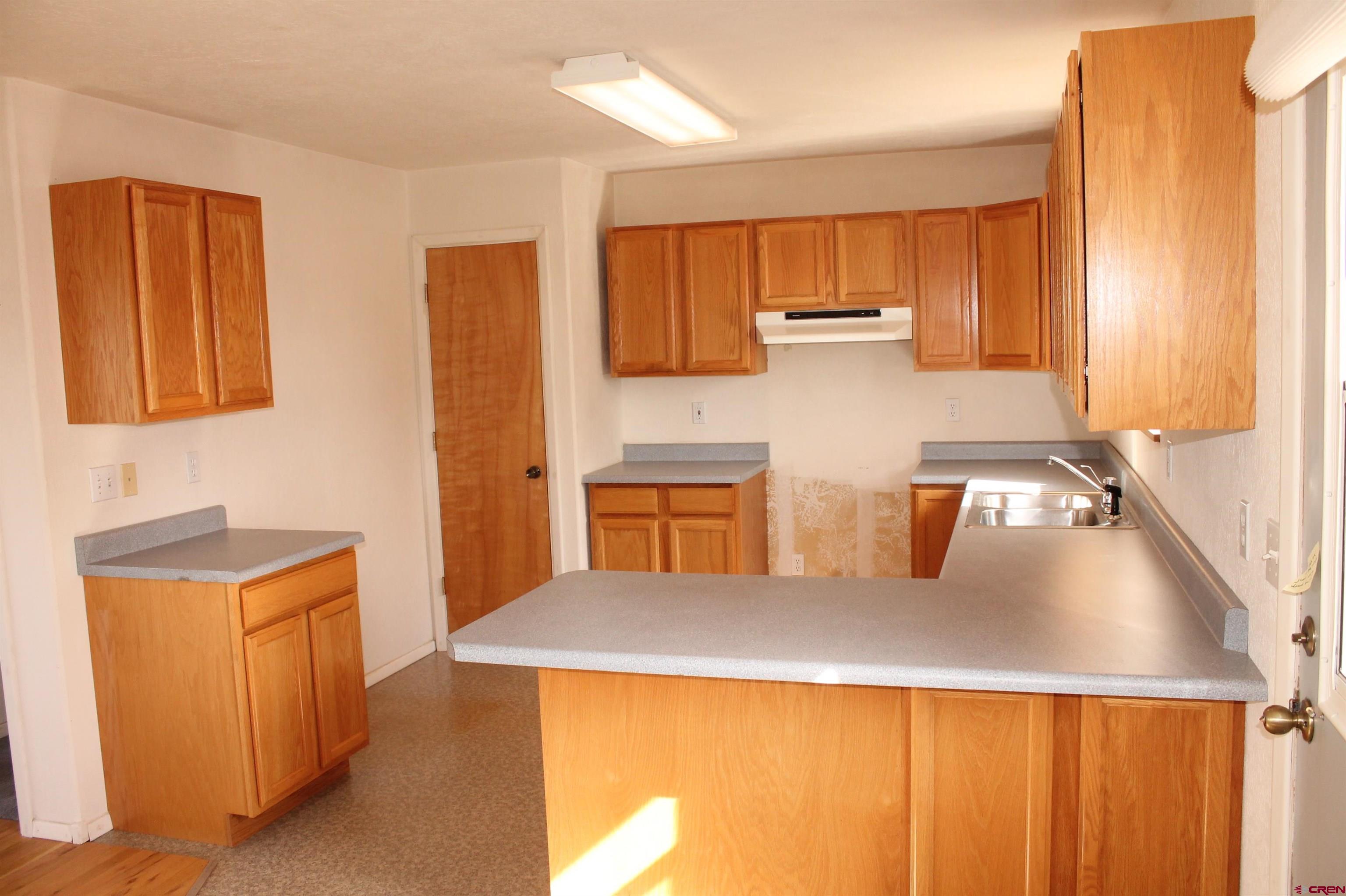 2944 County Road 510 Durango, CO 81303 - Photo 13 of 38 a kitchen with a sink a stove and a refrigerator