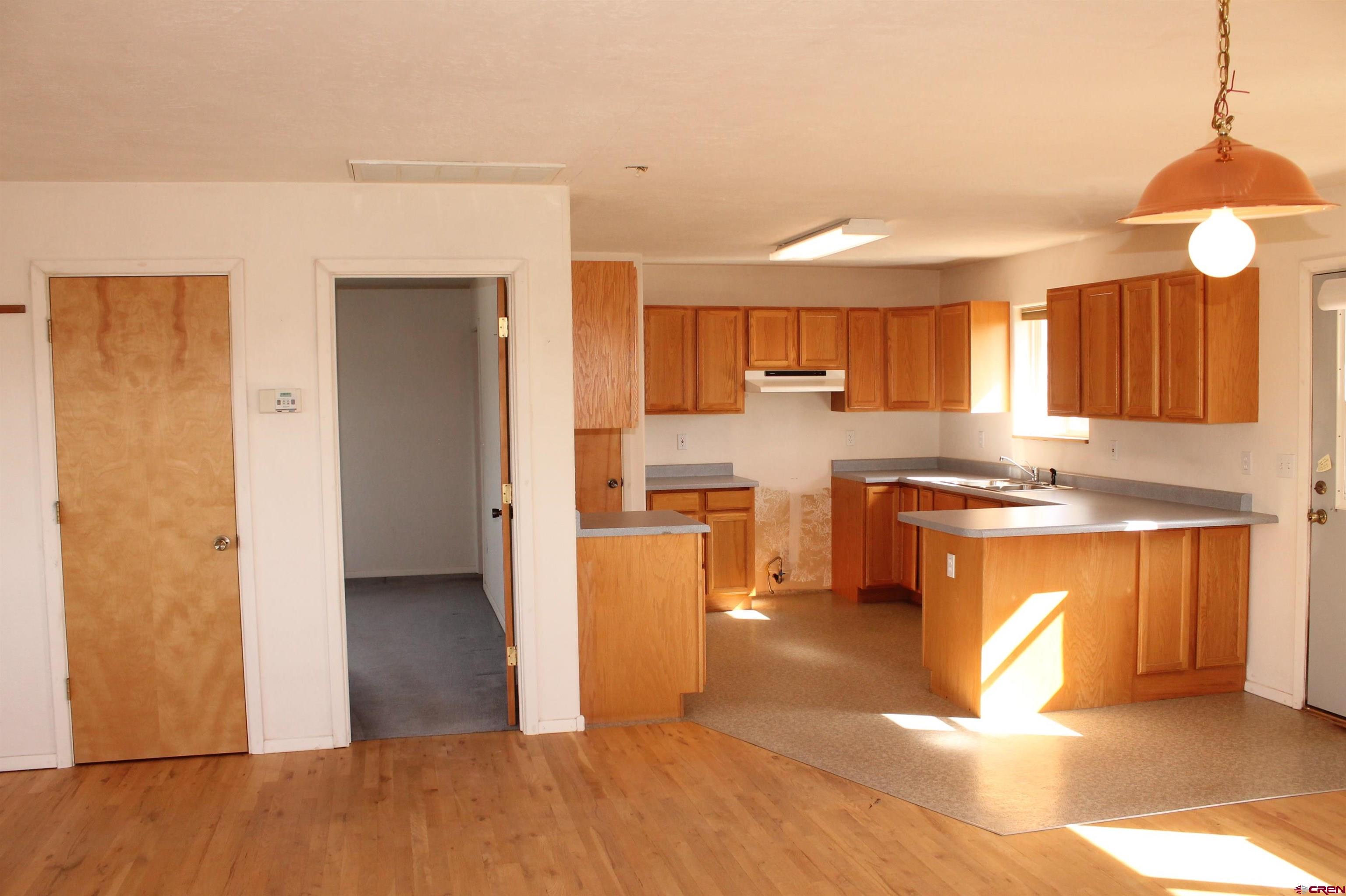 2944 County Road 510 Durango, CO 81303 - Photo 16 of 38 a kitchen with stainless steel appliances granite countertop a refrigerator a sink dishwasher a stove and white countertops with wooden floor
