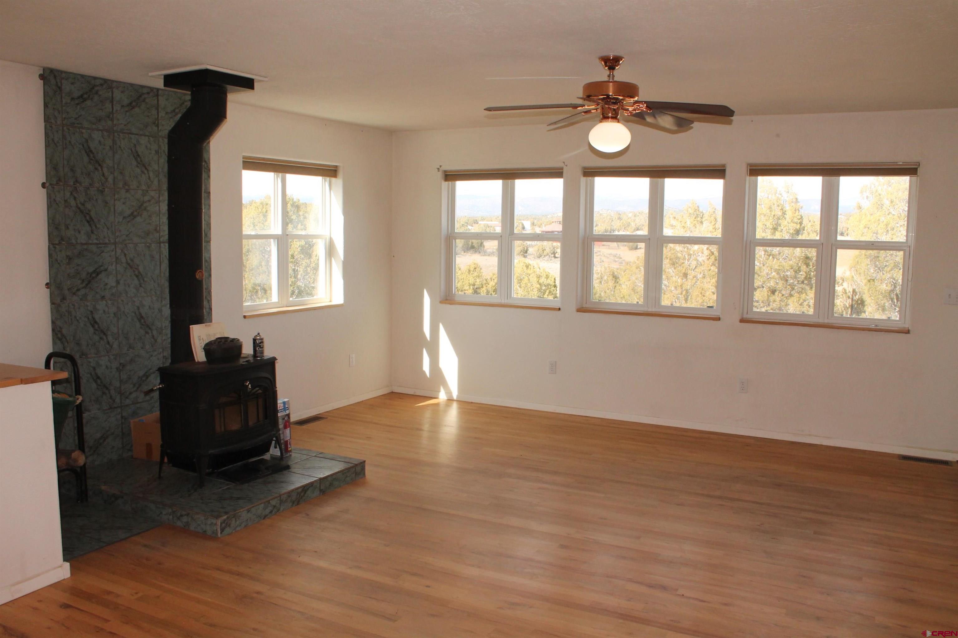 2944 County Road 510 Durango, CO 81303 - Photo 7 of 38 a living room with hardwood floor and a ceiling fan