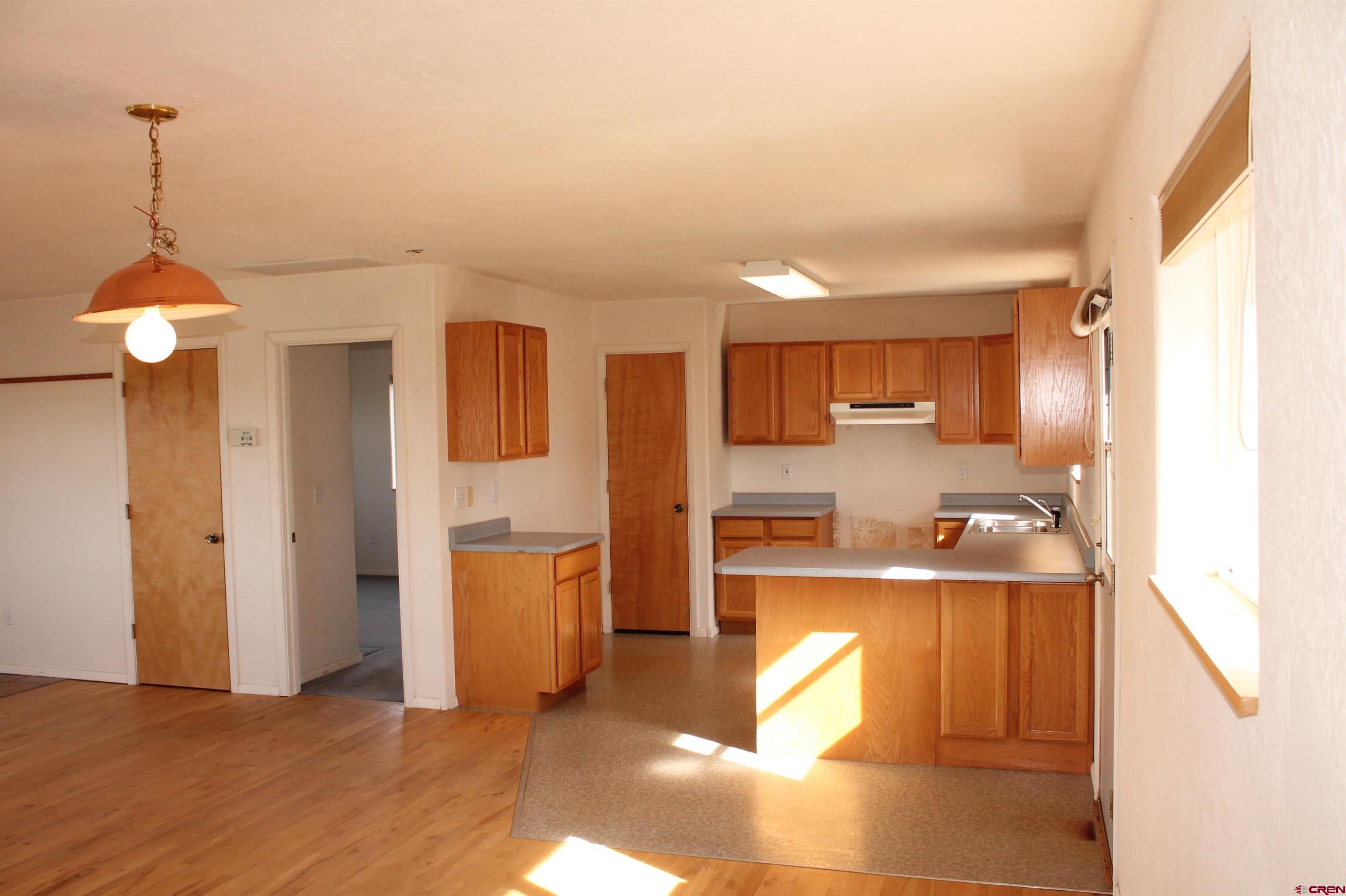 2944 County Road 510 Durango, CO 81303 - Photo 10 of 38 a kitchen with stainless steel appliances granite countertop a refrigerator a sink dishwasher a stove and a dining table with wooden floor