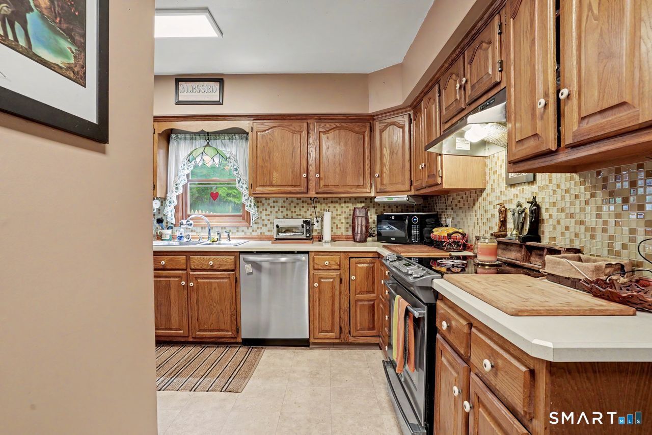74 Maple Street Seymour, CT 06483 - Photo 6 of 40 a kitchen with stainless steel appliances granite countertop a stove a sink dishwasher and a refrigerator