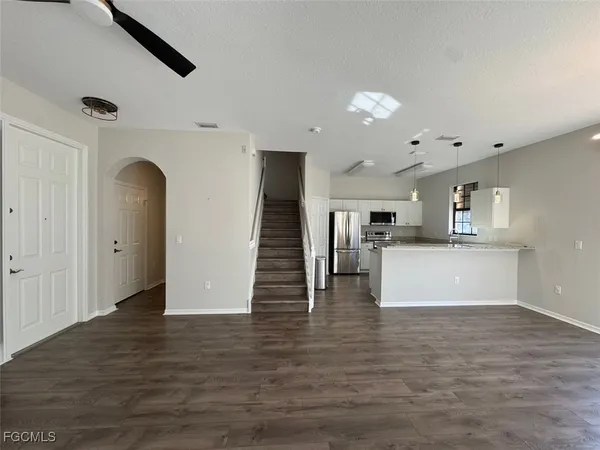 a view of kitchen and hall with wooden floor