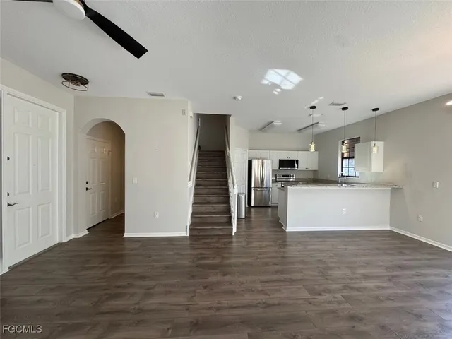 a view of kitchen and hall with wooden floor