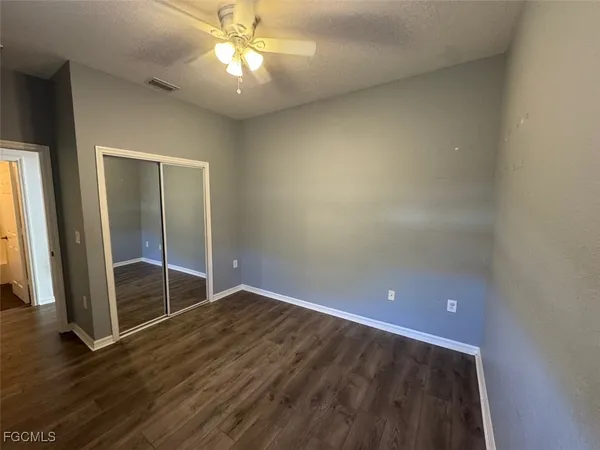 an empty room with wooden floor and door