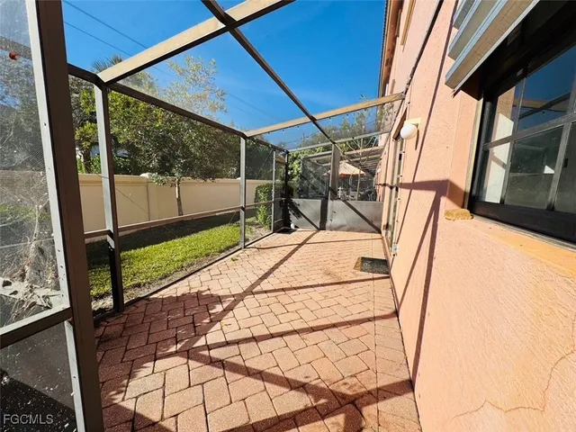 a view of a balcony with chairs and wooden fence