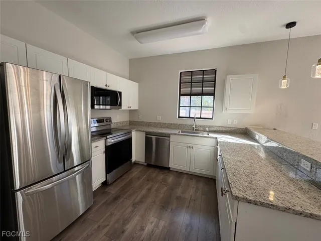 a kitchen with a refrigerator and a sink