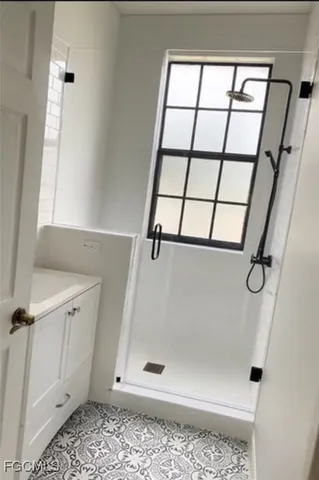 a bathroom with a glass shower door