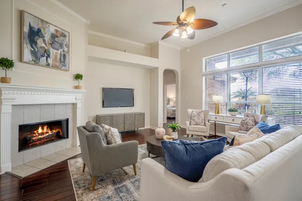 a bedroom with a bed chandelier and a window