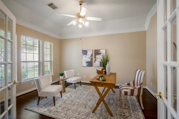 a view of a dining room with furniture and chandelier