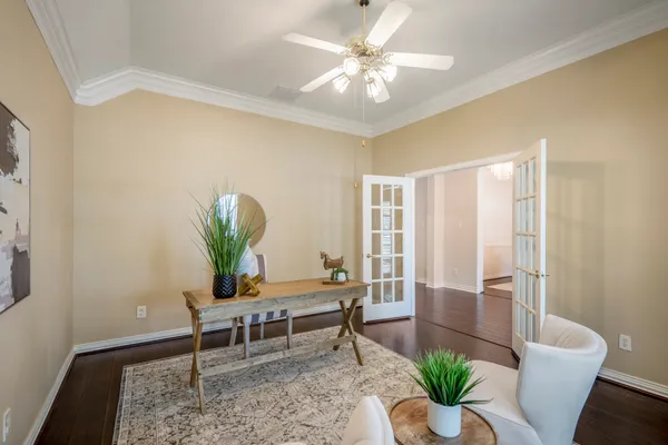 a living room with furniture a flat screen tv and a large window