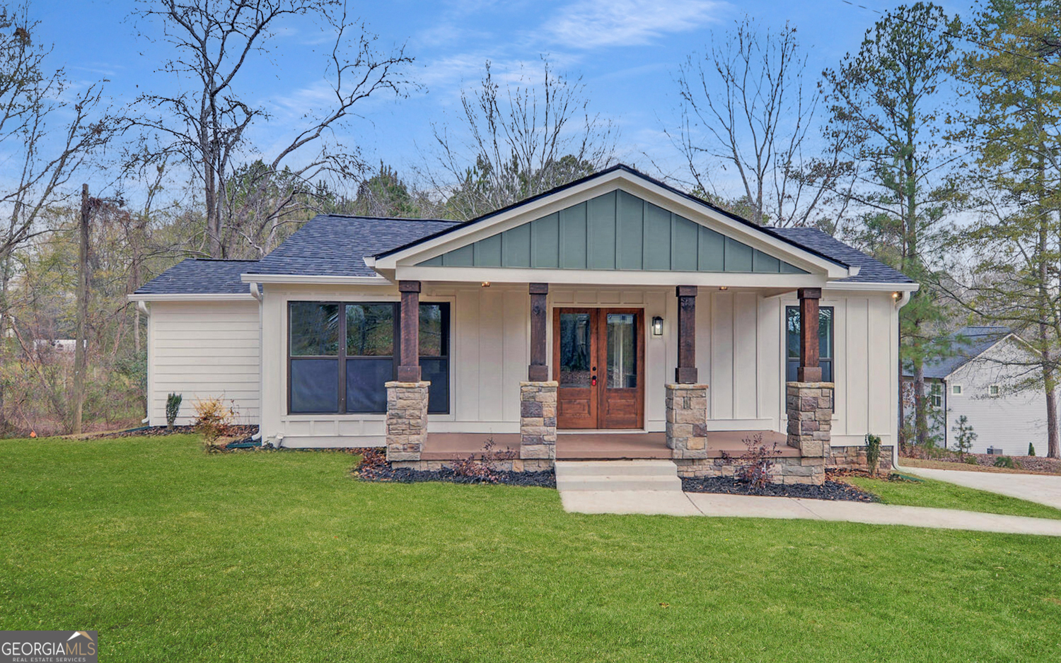 a front view of house with yard and green space