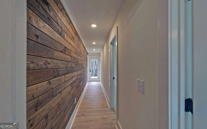 999 East Doyle Street Toccoa, GA 30577 - Photo 16 of 42 a view of a hallway with wooden floor and staircase