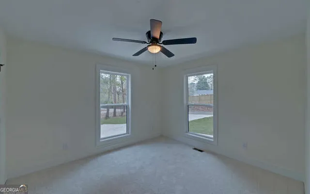 an empty room with window and windows