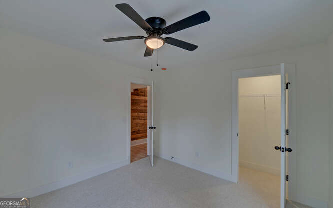 999 East Doyle Street Toccoa, GA 30577 - Photo 19 of 42 an empty room with closet and ceiling fan