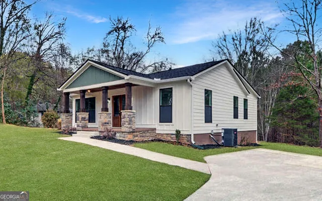 a front view of house with yard and outdoor seating