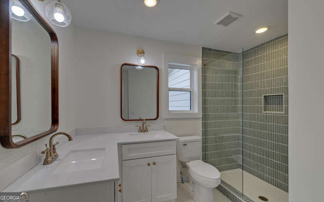 999 East Doyle Street Toccoa, GA 30577 - Photo 31 of 42 a bathroom with a toilet sink and mirror