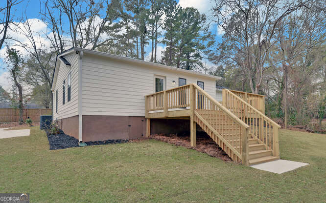 999 East Doyle Street Toccoa, GA 30577 - Photo 40 of 42 a view of a house with a yard