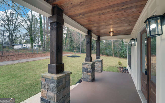 999 East Doyle Street Toccoa, GA 30577 - Photo 4 of 42 a view of a porch with furniture and a backyard