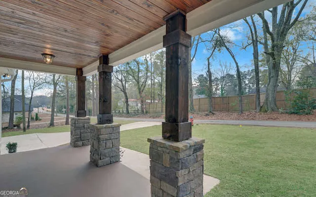 a view of swimming pool with a table and chairs in patio