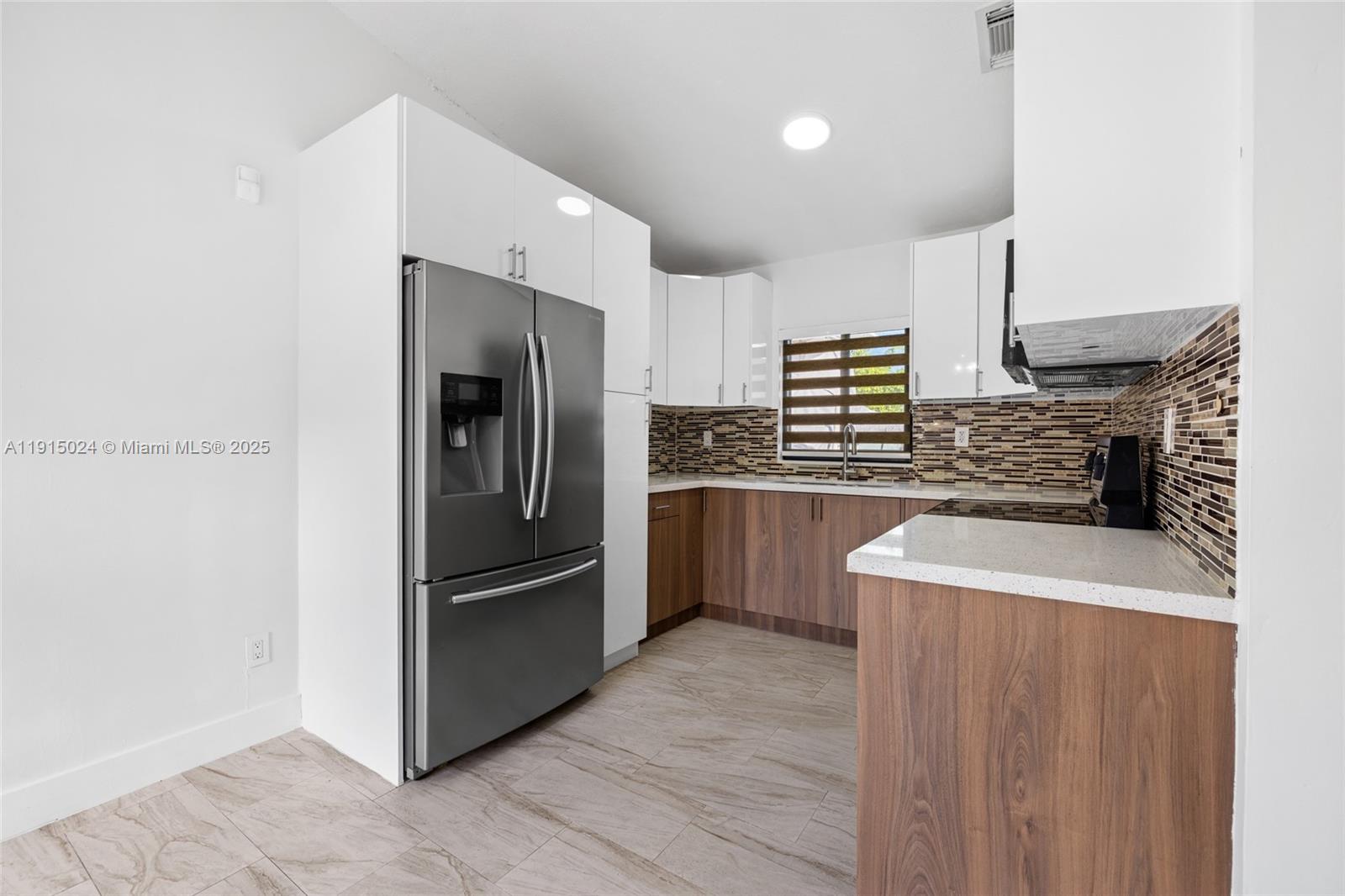 12740 Southwest 249th Terrace Homestead, FL 33032 - Photo 10 of 27 a kitchen with stainless steel appliances granite countertop a refrigerator a stove and a sink