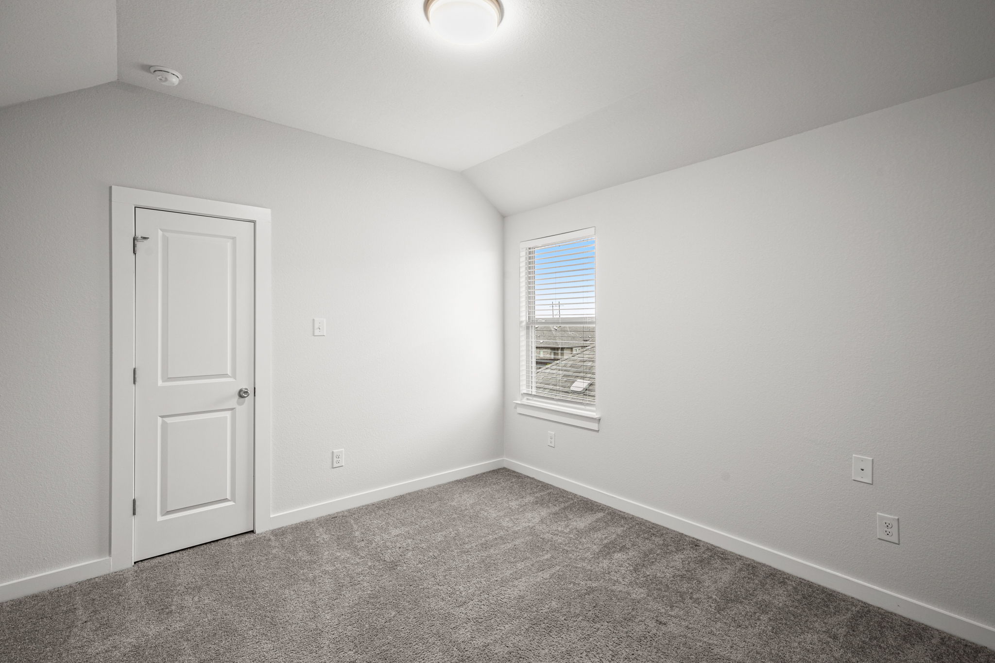 841 Spinnaker Loop Kyle, TX 78640 - Photo 32 of 40 Carpeted spare room featuring lofted ceiling and baseboards