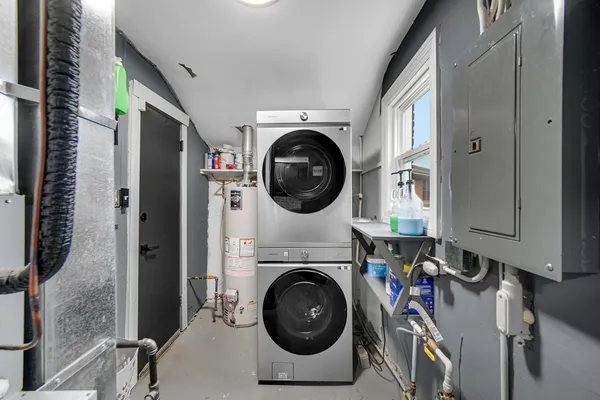a utility room with sink dryer and washer