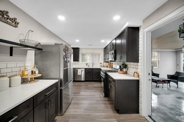 a kitchen with counter top space cabinets and stainless steel appliances