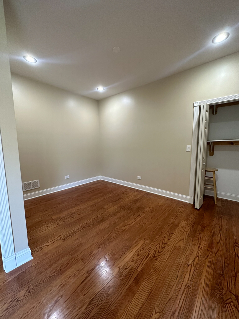 4336 South Indiana Avenue, Unit 1 Chicago, IL 60653 - Photo 12 of 15 a view of room with wooden floor and window