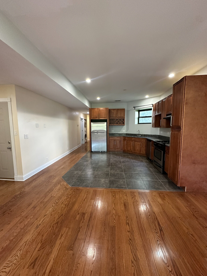 4336 South Indiana Avenue, Unit 1 Chicago, IL 60653 - Photo 7 of 15 a view of kitchen with cabinets and wooden floor