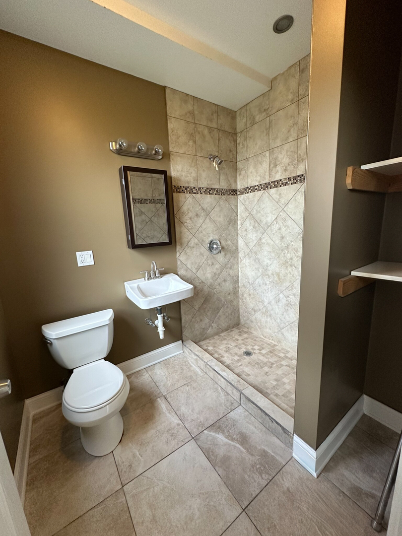 4336 South Indiana Avenue, Unit 1 Chicago, IL 60653 - Photo 8 of 15 a bathroom with a toilet and a shower
