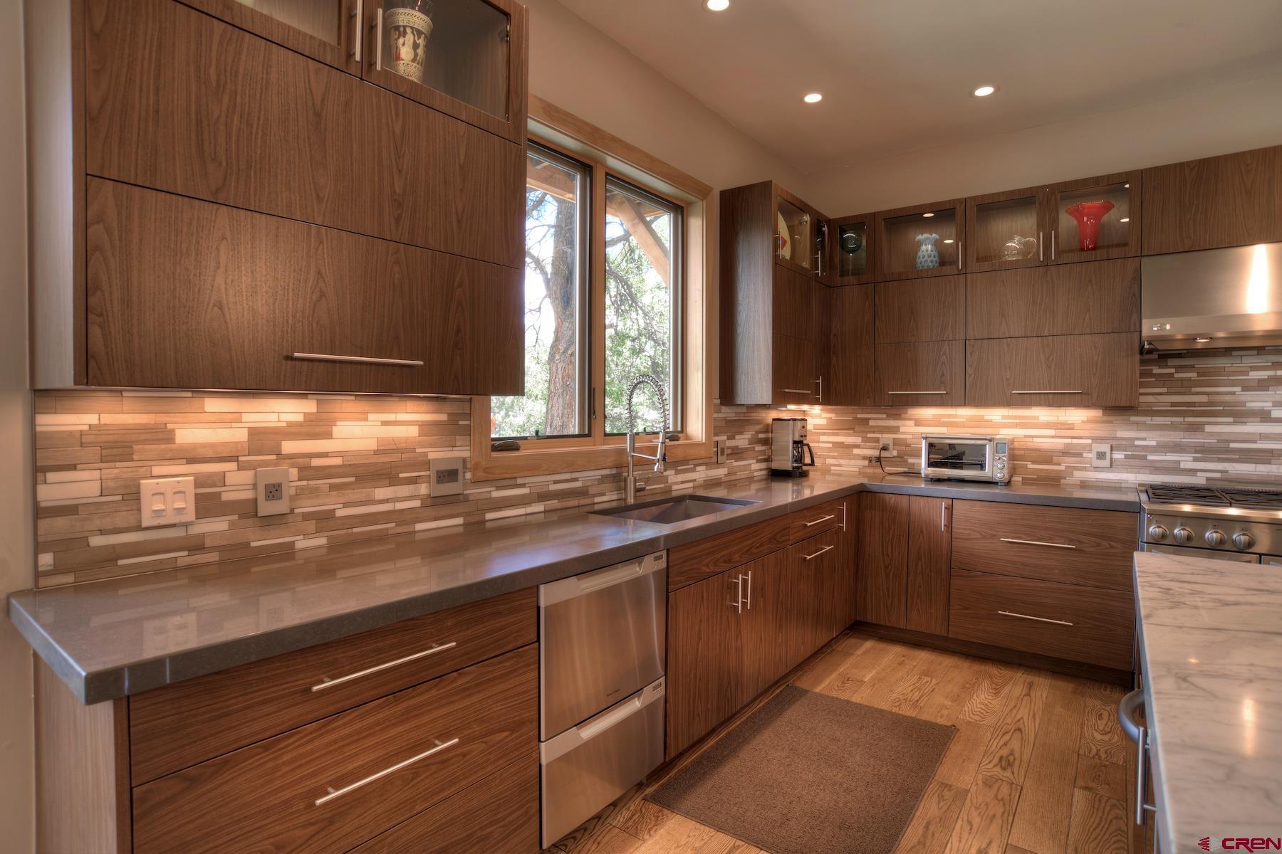 15 Eagle Ridge Road Durango, CO 81301 - Photo 11 of 35 a kitchen with a sink stove and cabinets