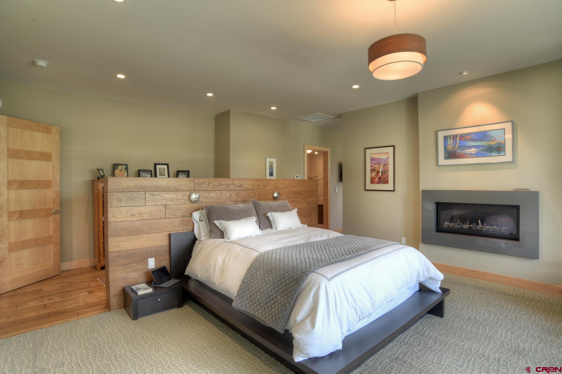 15 Eagle Ridge Road Durango, CO 81301 - Photo 14 of 35 a spacious bedroom with a bed and a chandelier