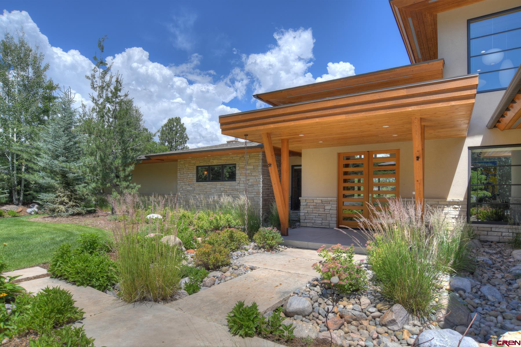 15 Eagle Ridge Road Durango, CO 81301 - Photo 3 of 35 a front view of a house with garden