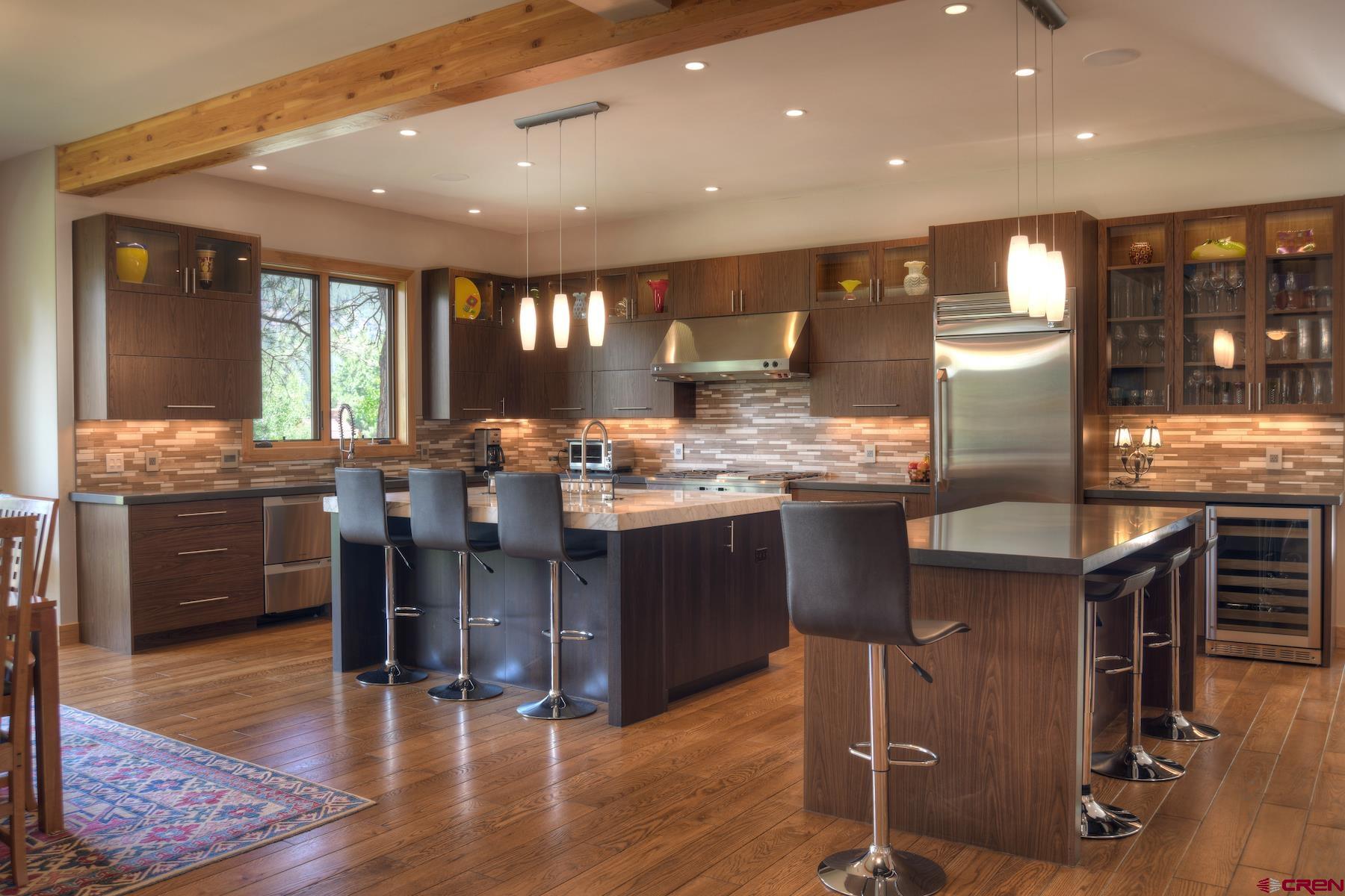 15 Eagle Ridge Road Durango, CO 81301 - Photo 8 of 35 a kitchen with stainless steel appliances dining table chairs and wooden floor
