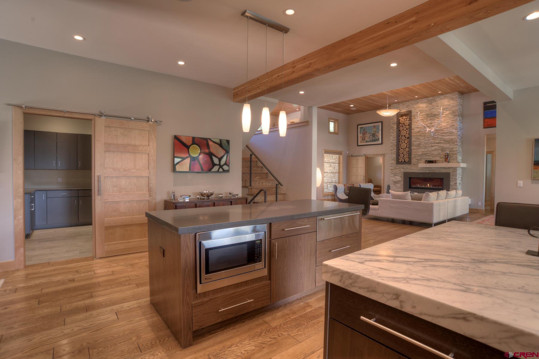 15 Eagle Ridge Road Durango, CO 81301 - Photo 9 of 35 a kitchen with stainless steel appliances kitchen island granite countertop a stove and a sink