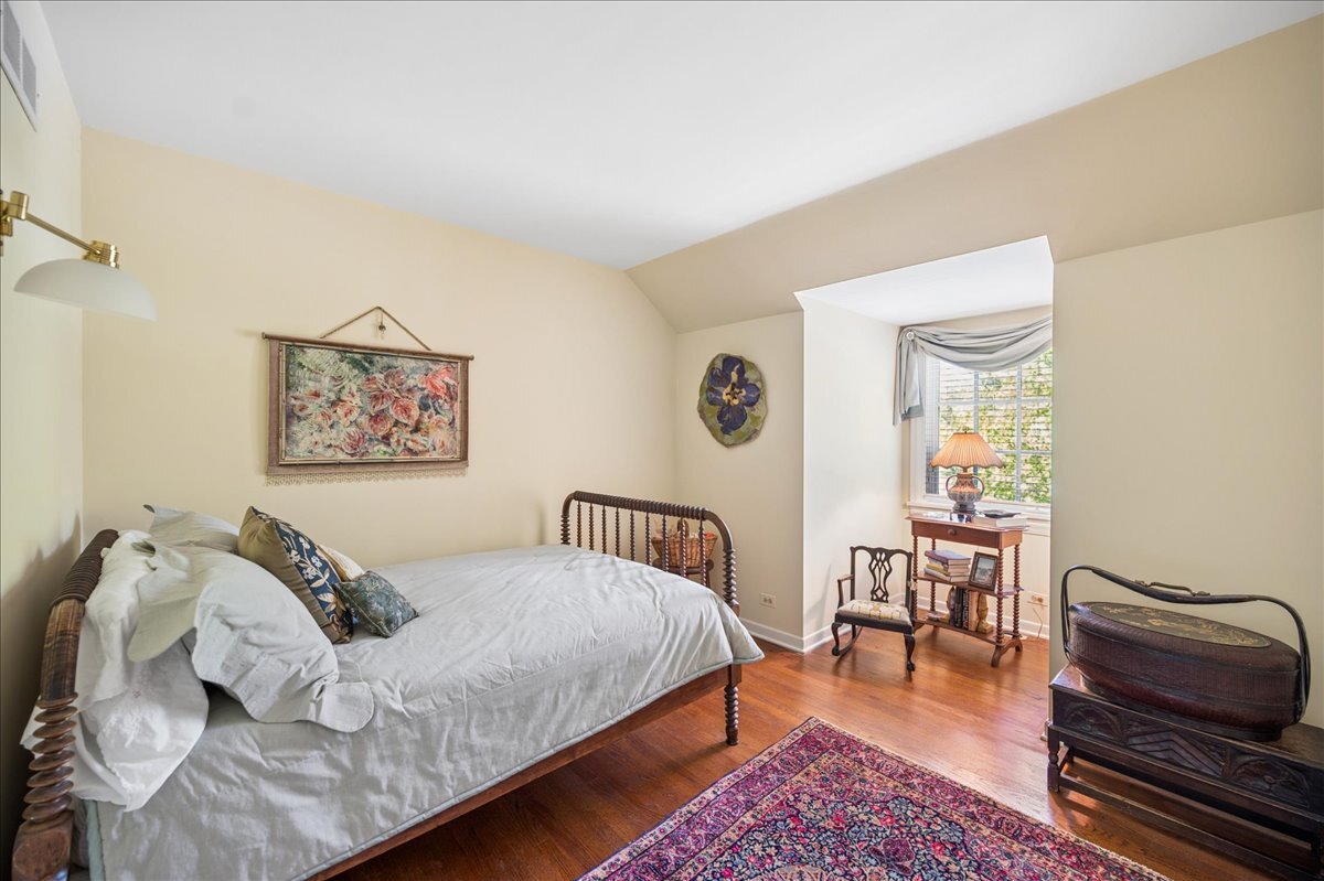 253 Summerfield Road Northbrook, IL 60062 - Photo 30 of 46 a bedroom with a bed and wooden floor