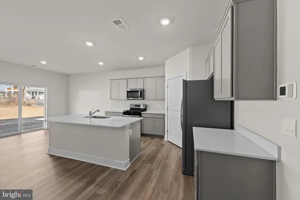 a kitchen with a sink stainless steel appliances and cabinets