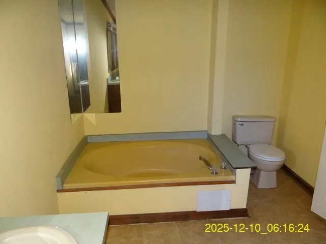 a bathroom with a toilet and tub