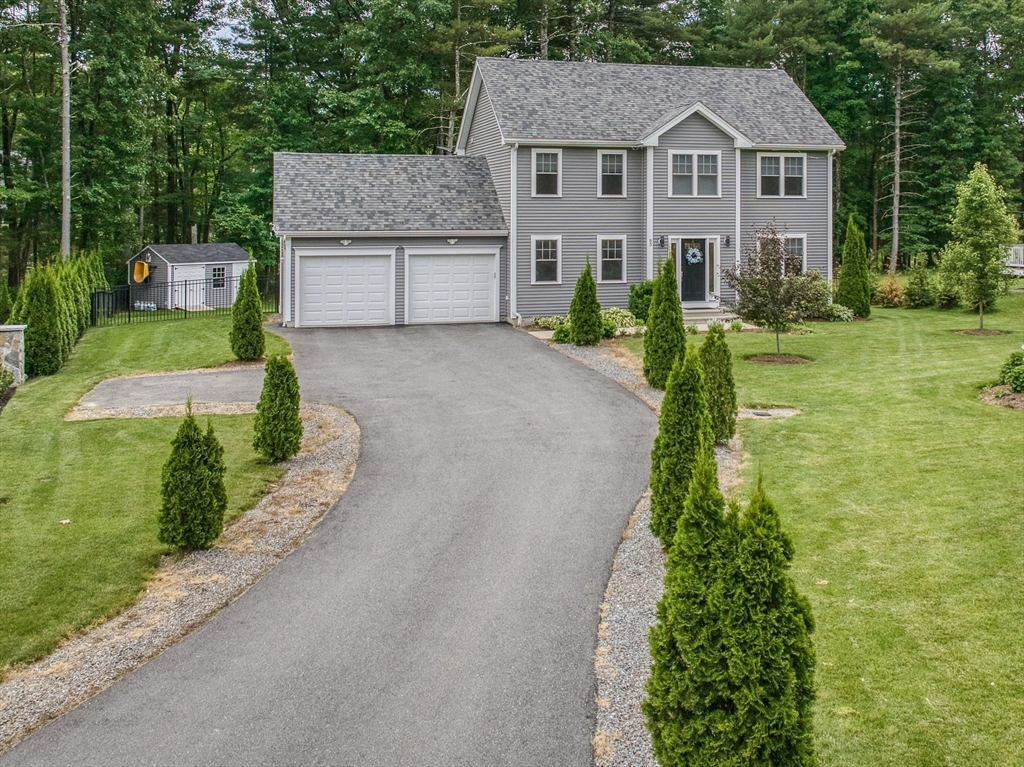 83 Littleton Road Ayer, MA 01432 - Photo 1 of 42 a front view of a house with a yard