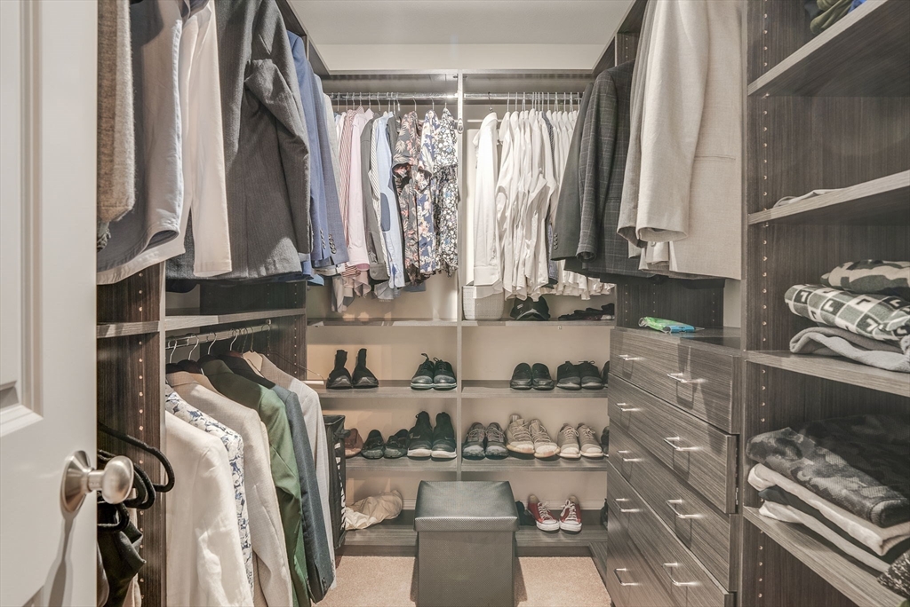 83 Littleton Road Ayer, MA 01432 - Photo 19 of 42 a view of walk in closet with clothes and shoes