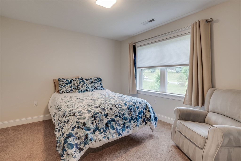 83 Littleton Road Ayer, MA 01432 - Photo 24 of 42 a bedroom with a bed and a couch