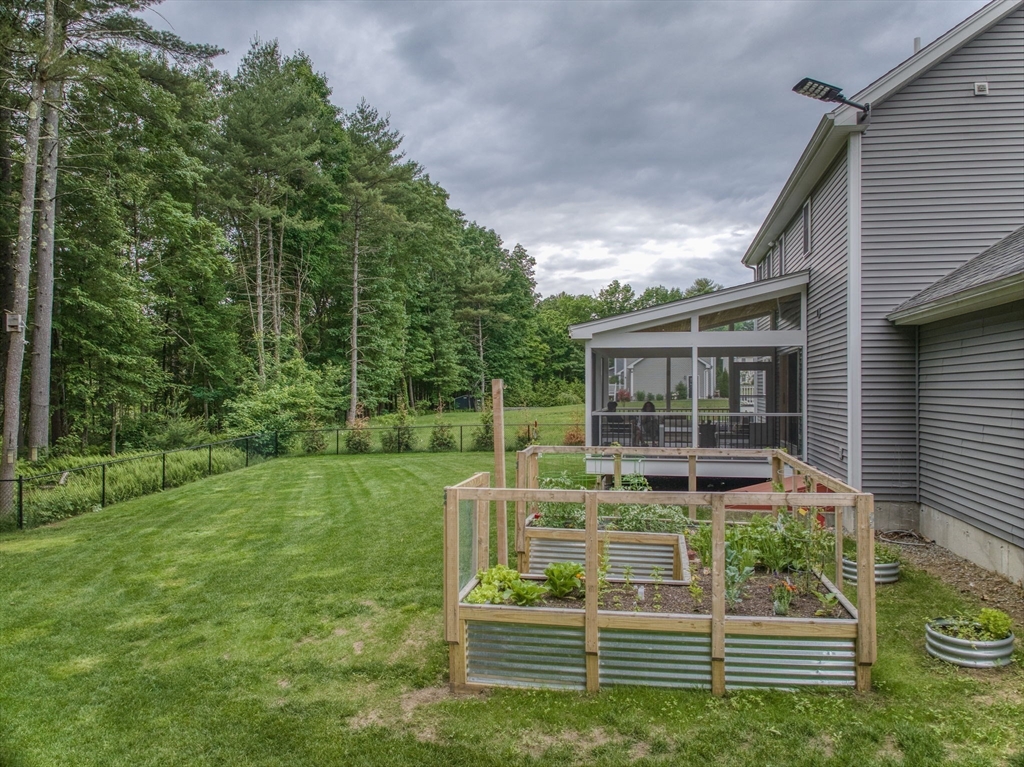 83 Littleton Road Ayer, MA 01432 - Photo 29 of 42 a backyard of a house with barbeque oven