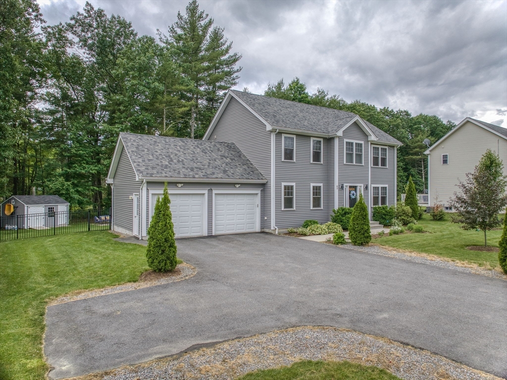83 Littleton Road Ayer, MA 01432 - Photo 40 of 42 a front view of a house with a garden and yard
