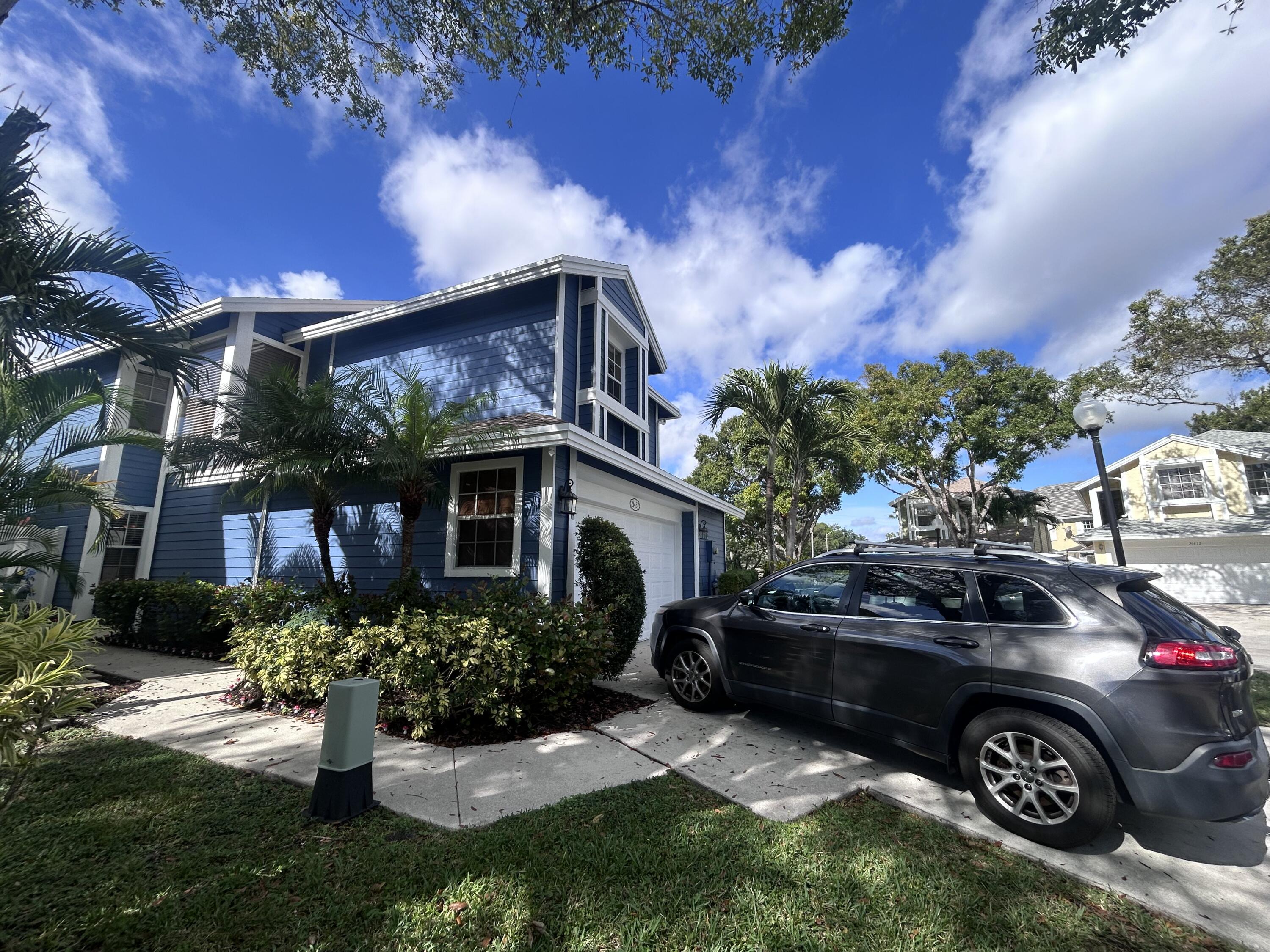 a front view of a house with a garden