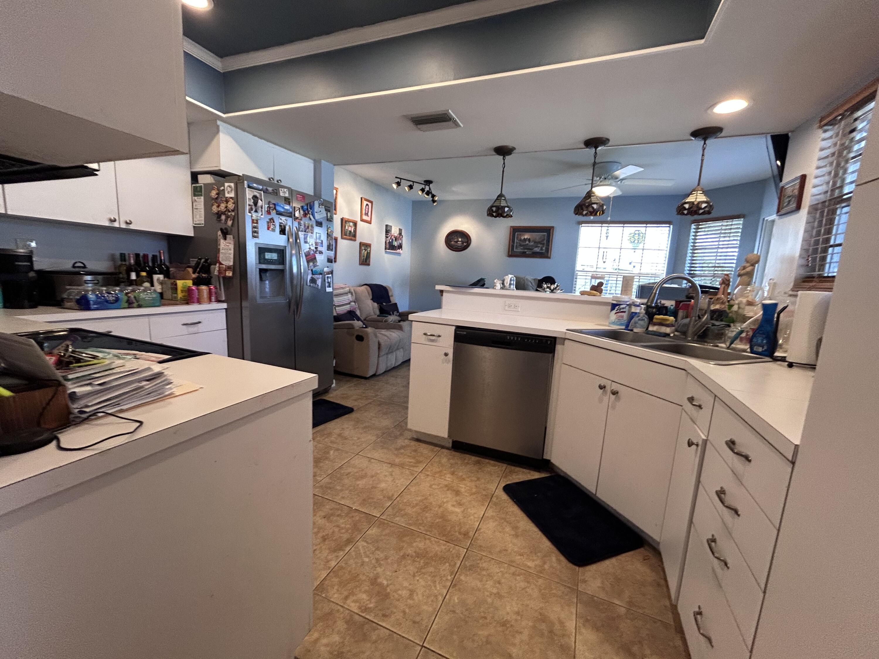 21437 54th Drive South Boca Raton, FL 33431 - Photo 5 of 15 a kitchen with a sink cabinets and stainless steel appliances
