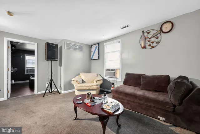 a living room with furniture a rug and a window