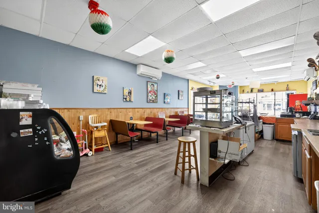 a living room with lots of furniture and a wooden floor