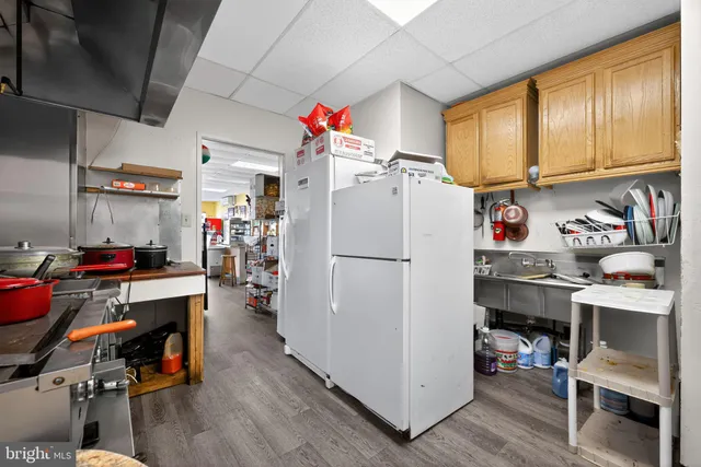 a white refrigerator freezer sitting inside of a kitchen