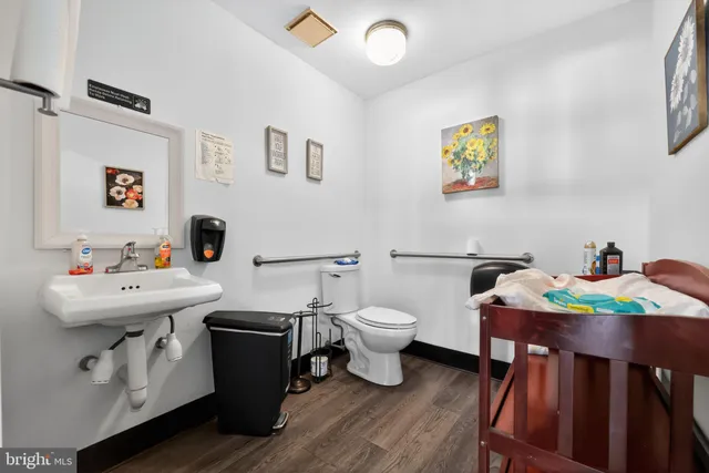 a bathroom with a sink a toilet and a mirror